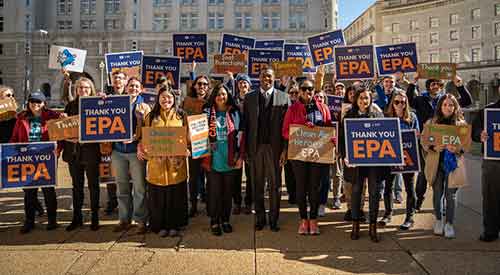 Crowd of people holding signs reading Thank You EPA