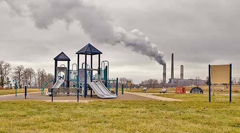 Playground with smokestack in the background