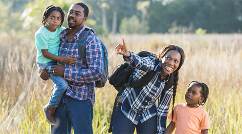 Black family hiking in nature