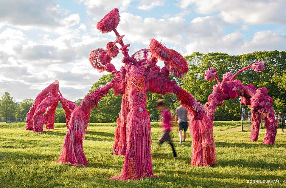 An image of 3 steel sculptures sheathed in abandoned fishing gear.