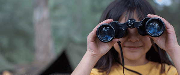 Child looking through binoculars