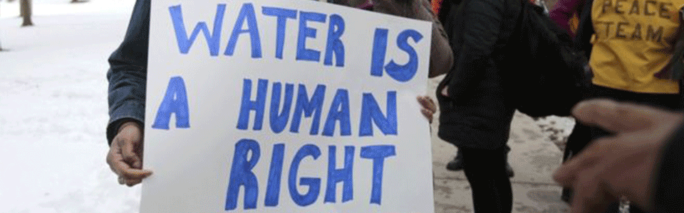 Poster reading Water is a Human Right written in blue marker